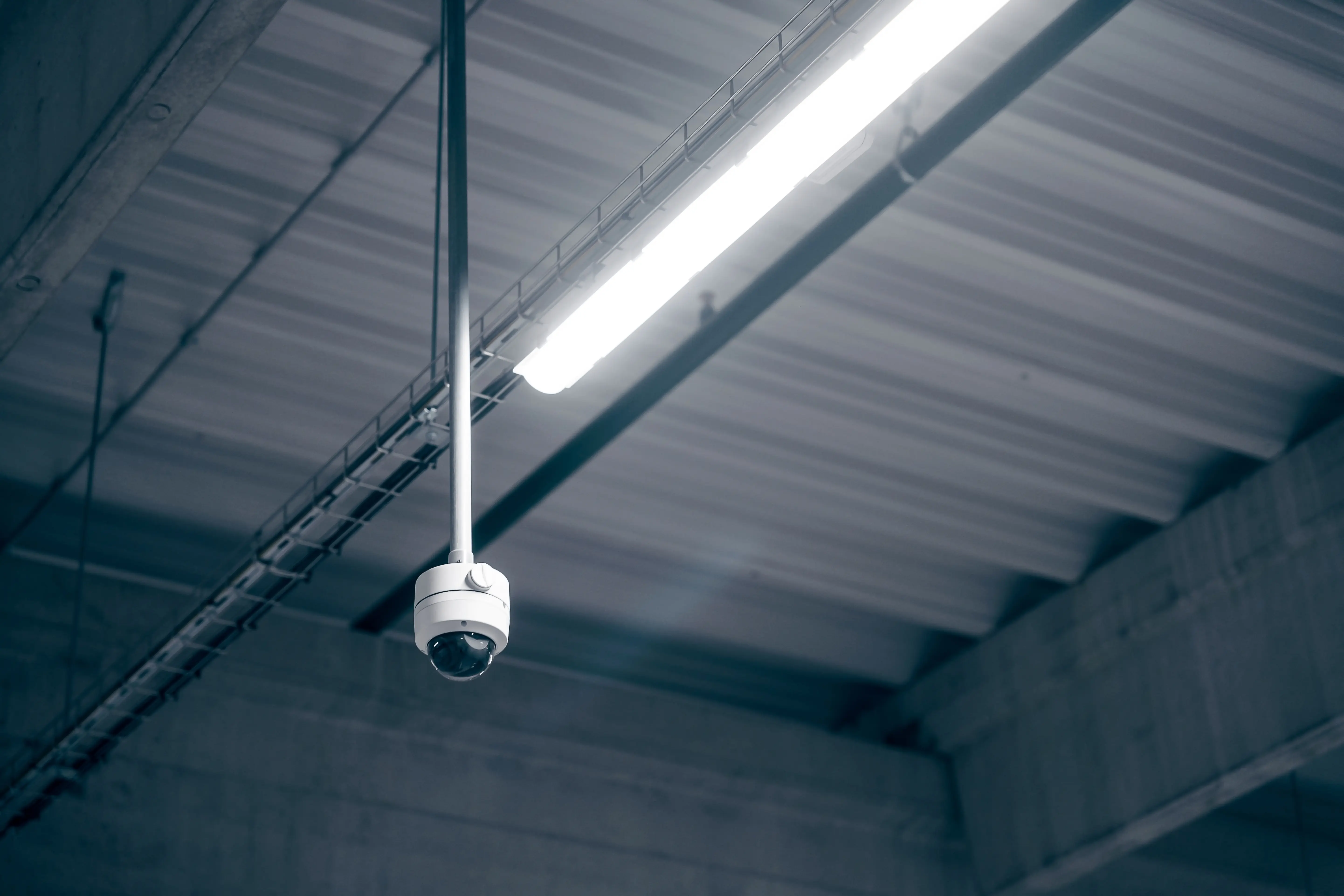 Ceiling mounted CCTV camera in a commercial space.