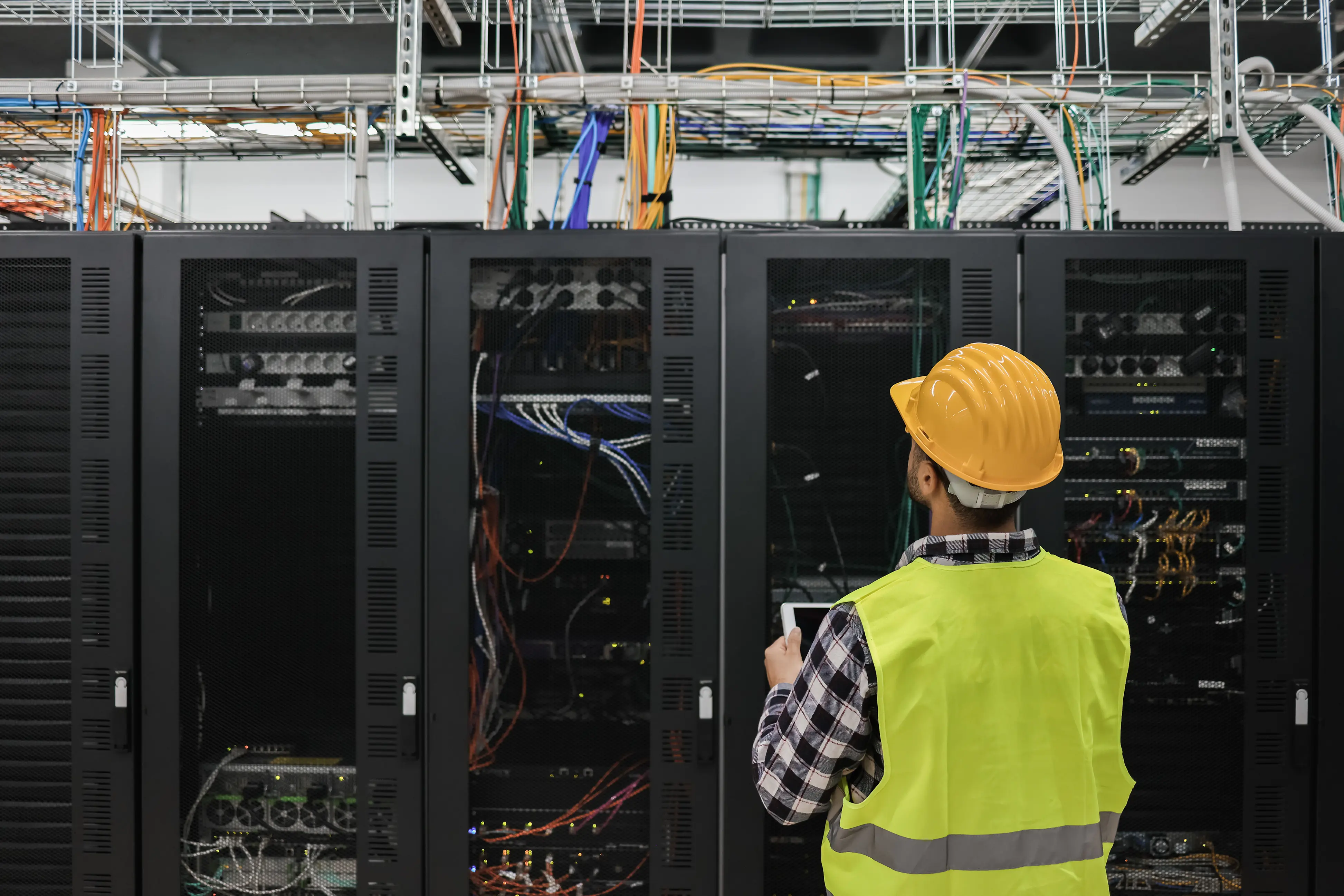 Alarm and monitoring equipment inspected inside a data closet.