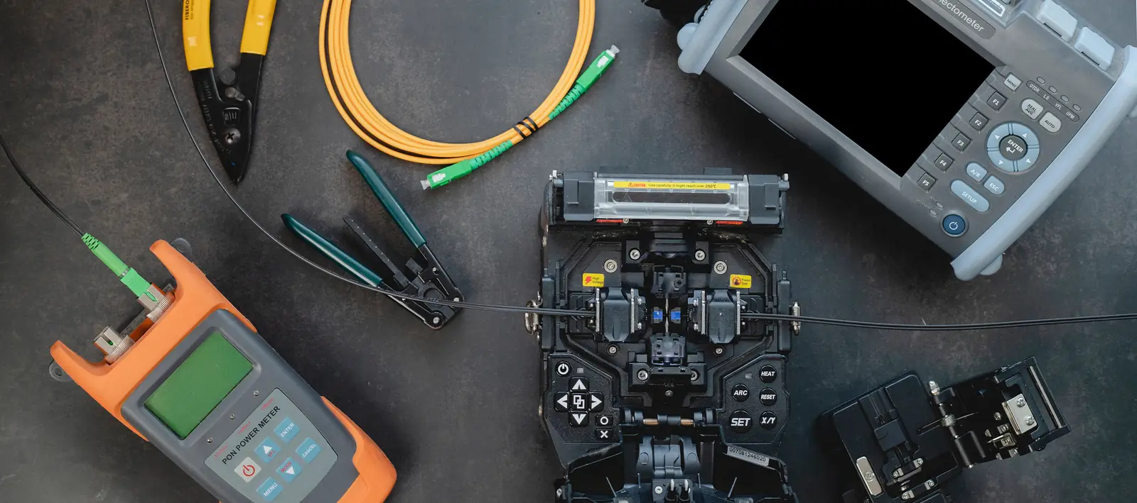 Fiber tools and inspection gear laid out for splicing.