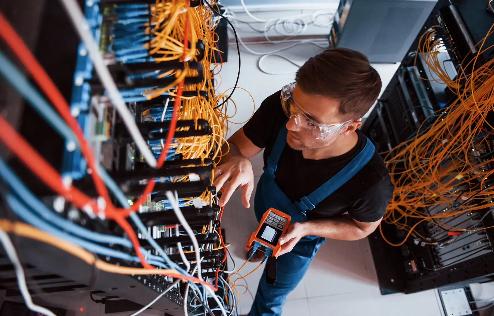 Technician testing a network rack during onsite support.