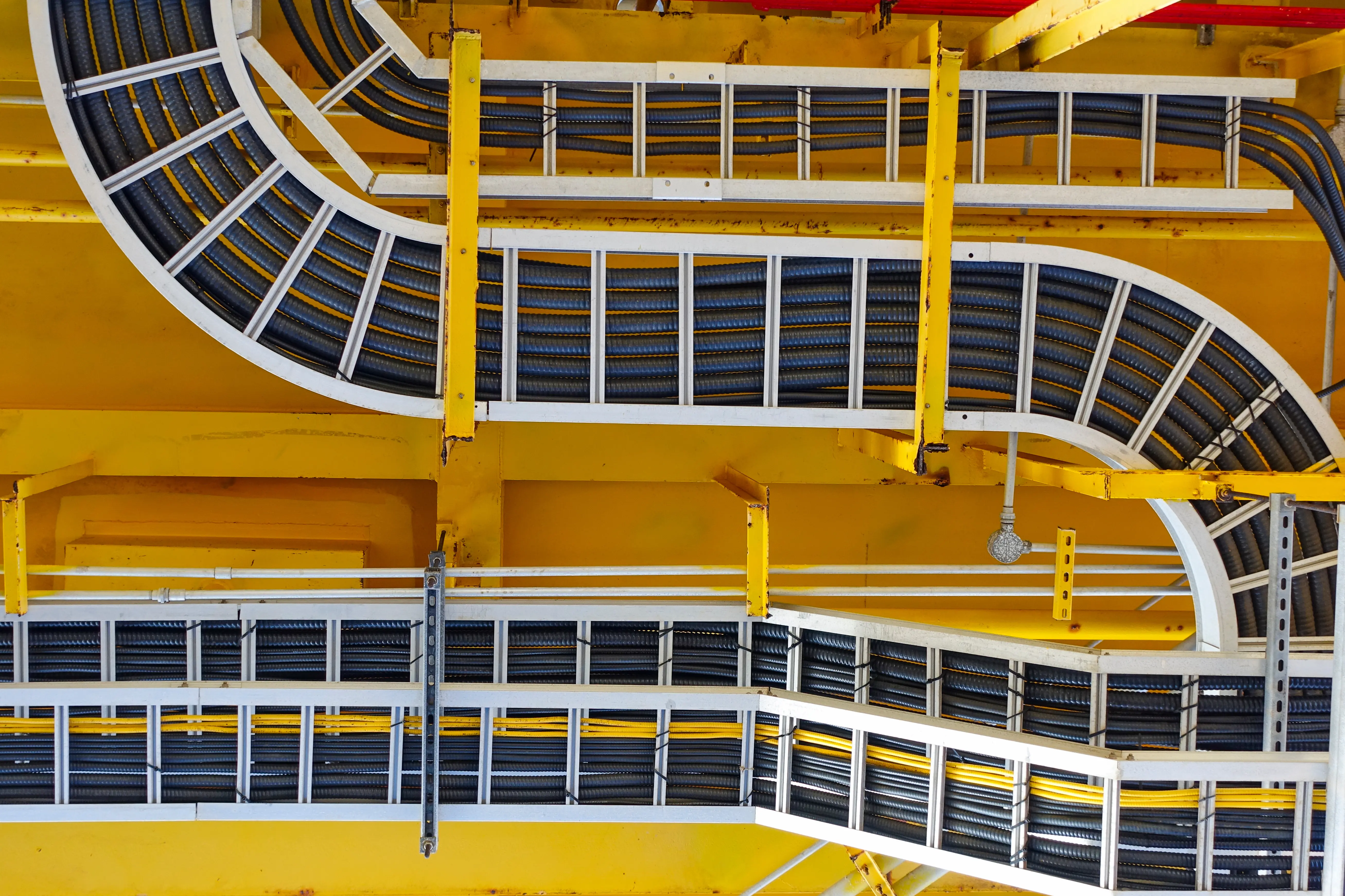 Overhead cable pathways routed along a commercial structure.