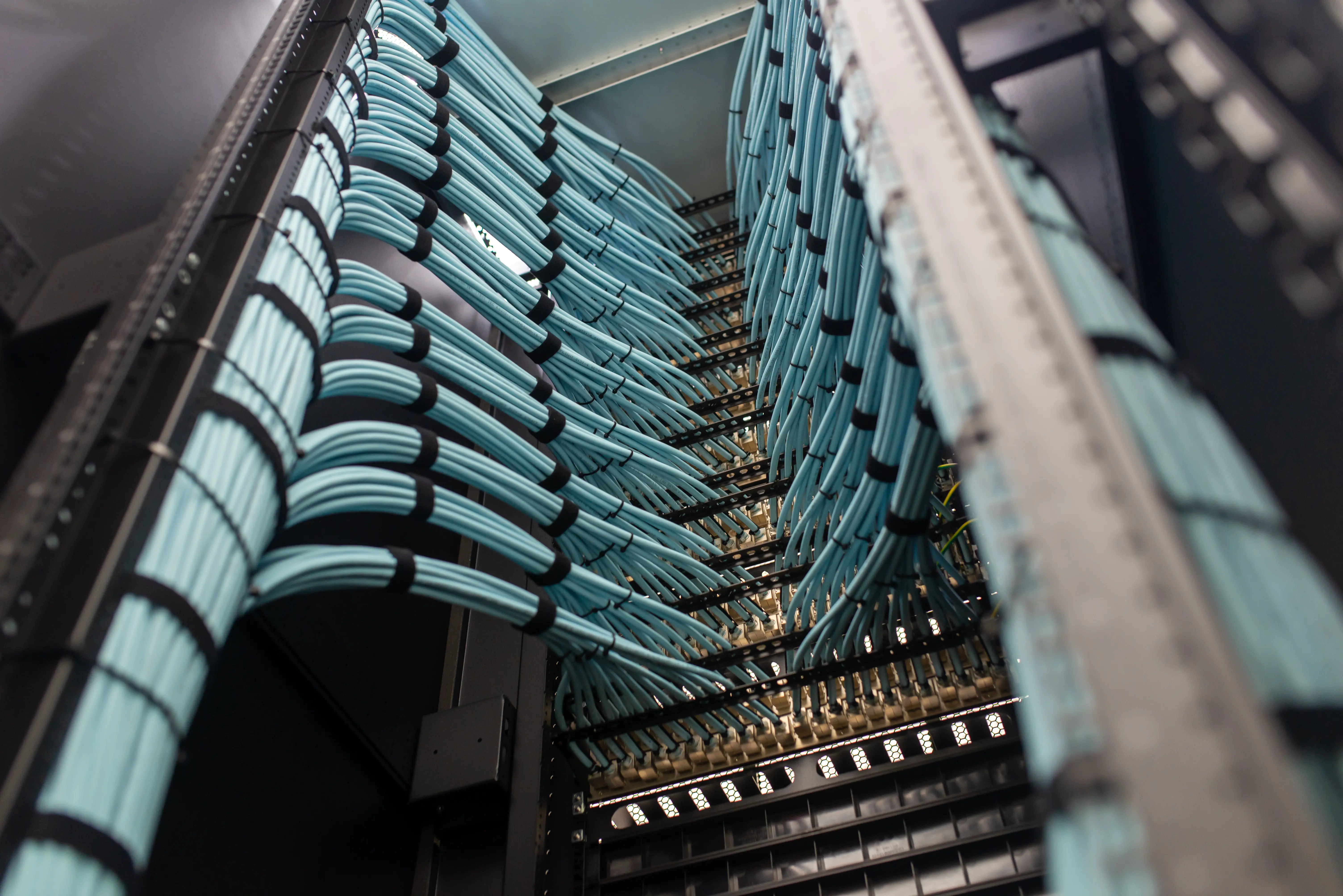 Vertical cable management installed neatly in a telecom room.