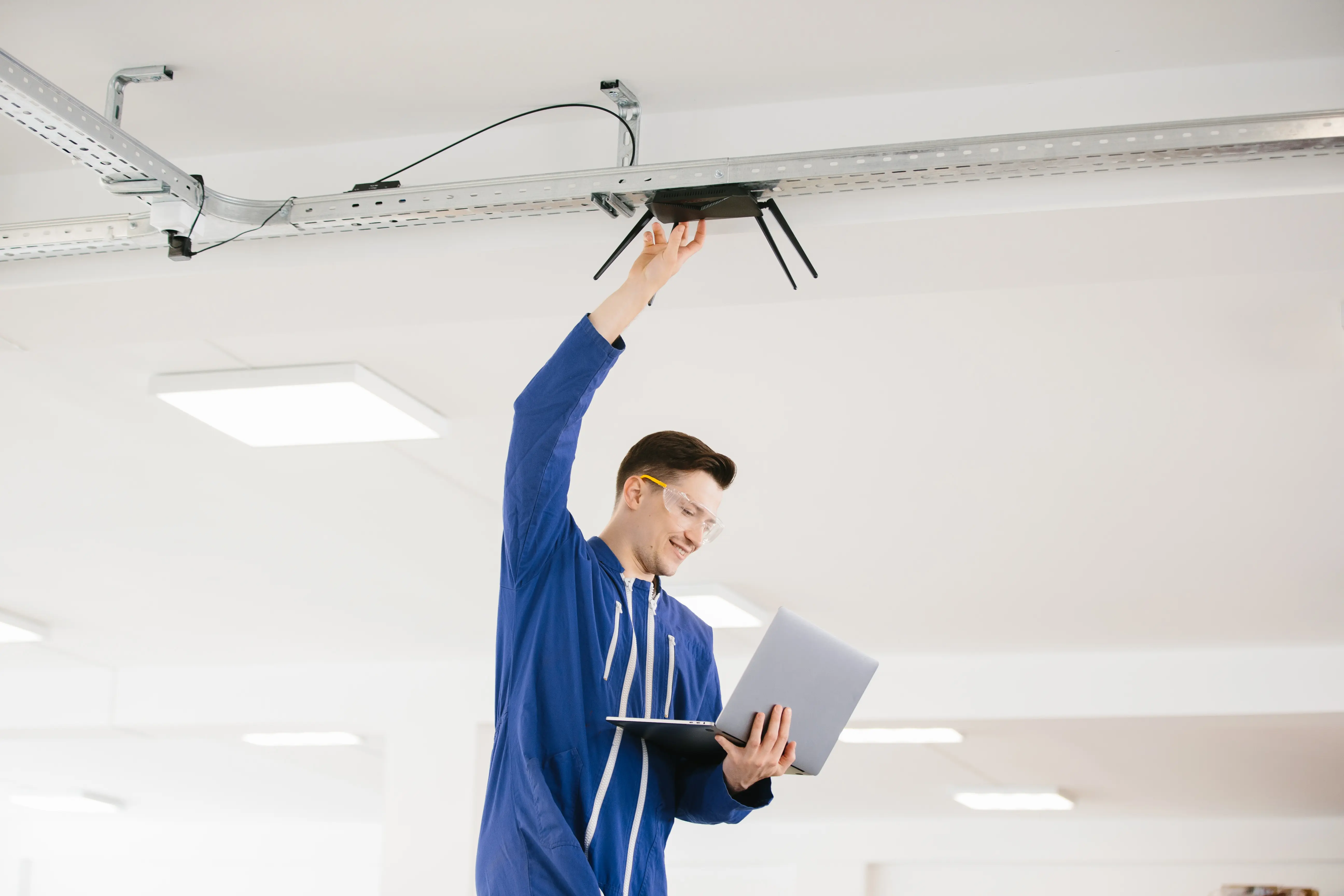 Field technician installing wireless access point cabling.